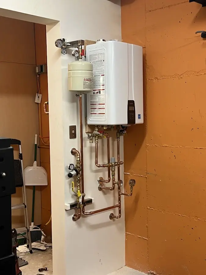 Plumbing technician inspecting water heater connections in Carson City